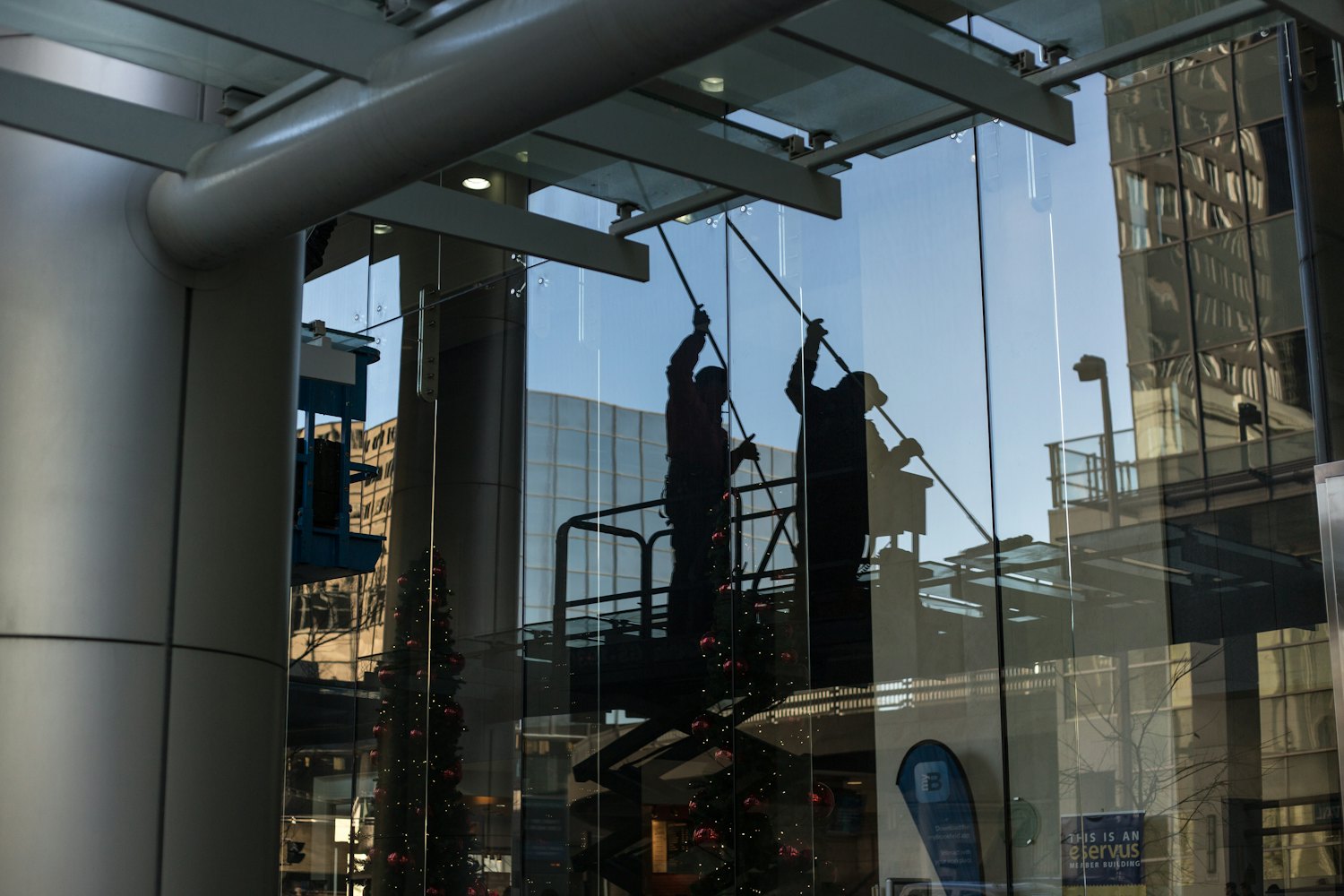 Professional cleaners washing the exterior glass of a commercial high-rise in Edmonton